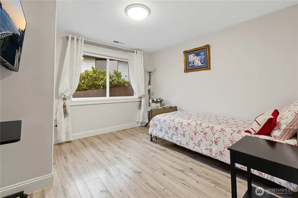 a bedroom with a bed and a window