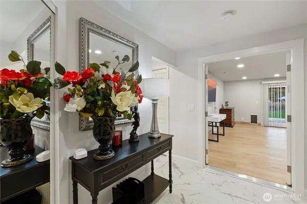 a living room with furniture and a potted plant