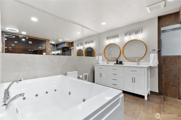 a bathroom with a double vanity sink and a mirror