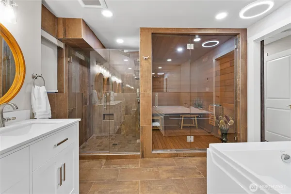 a bathroom with a mirror a sink and glass door