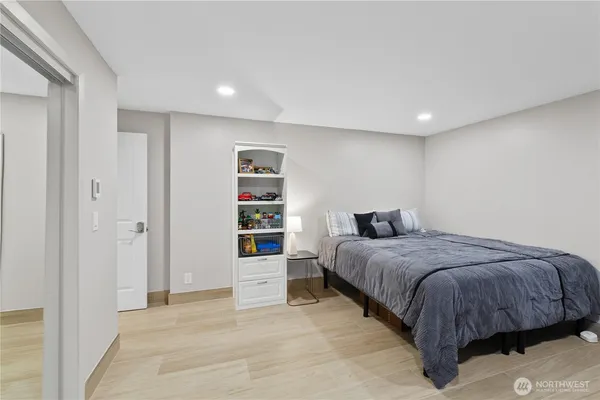 a spacious bedroom with a bed and a cabinets