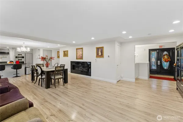 a living room with furniture and a dining table with kitchen view