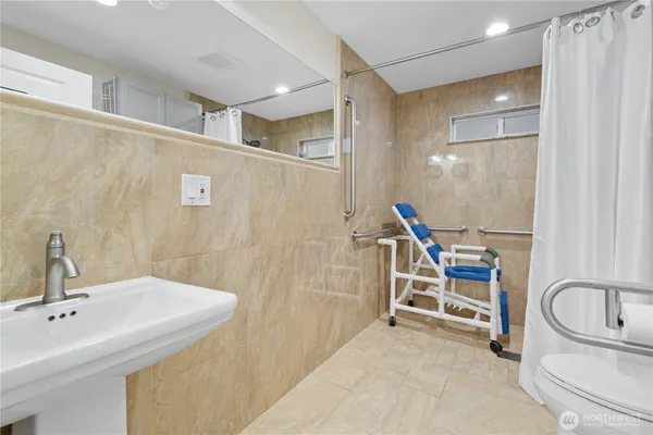 a bathroom with a sink a toilet and a shower