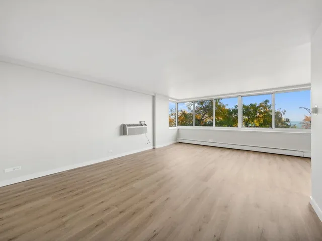 a view of an empty room and wooden floor