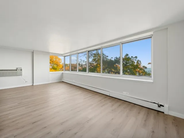 a kitchen with a refrigerator sink and cabinets