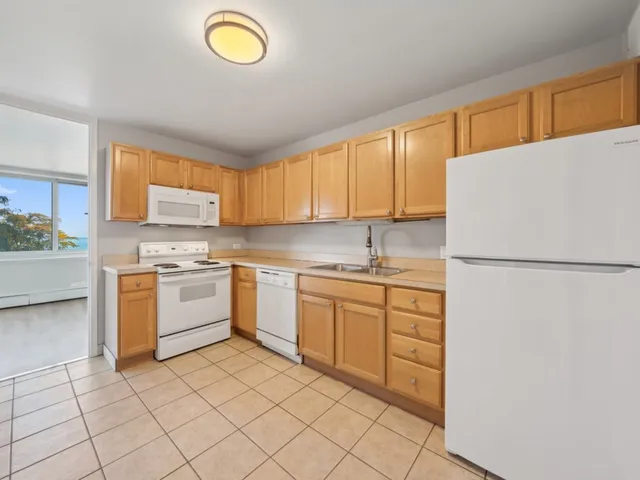 a kitchen with cabinets appliances and a sink