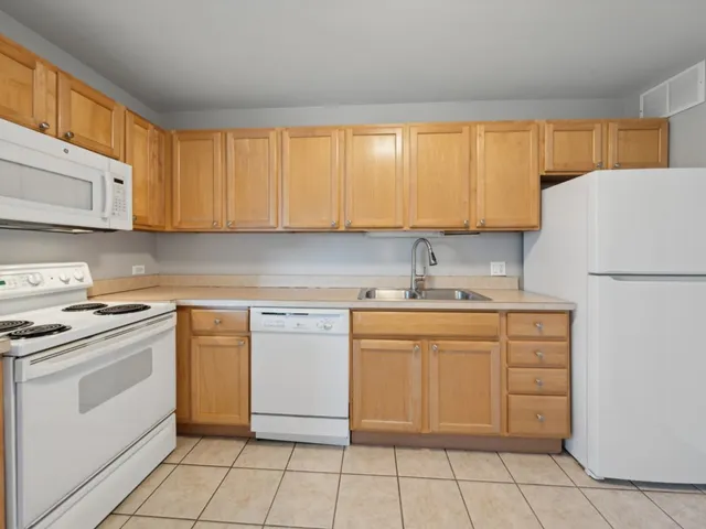 a kitchen with a stove sink and cabinets