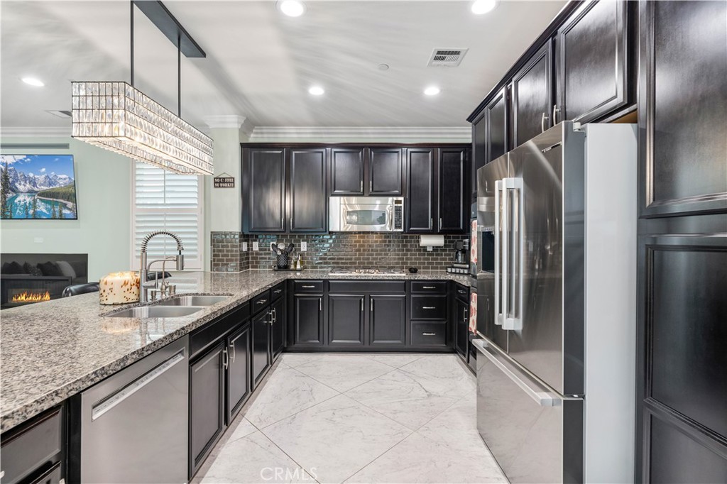 28537 Vista Del Rio Drive Valencia, CA 91354 - Photo 15 of 53 a large kitchen with granite countertop stainless steel appliances and a sink