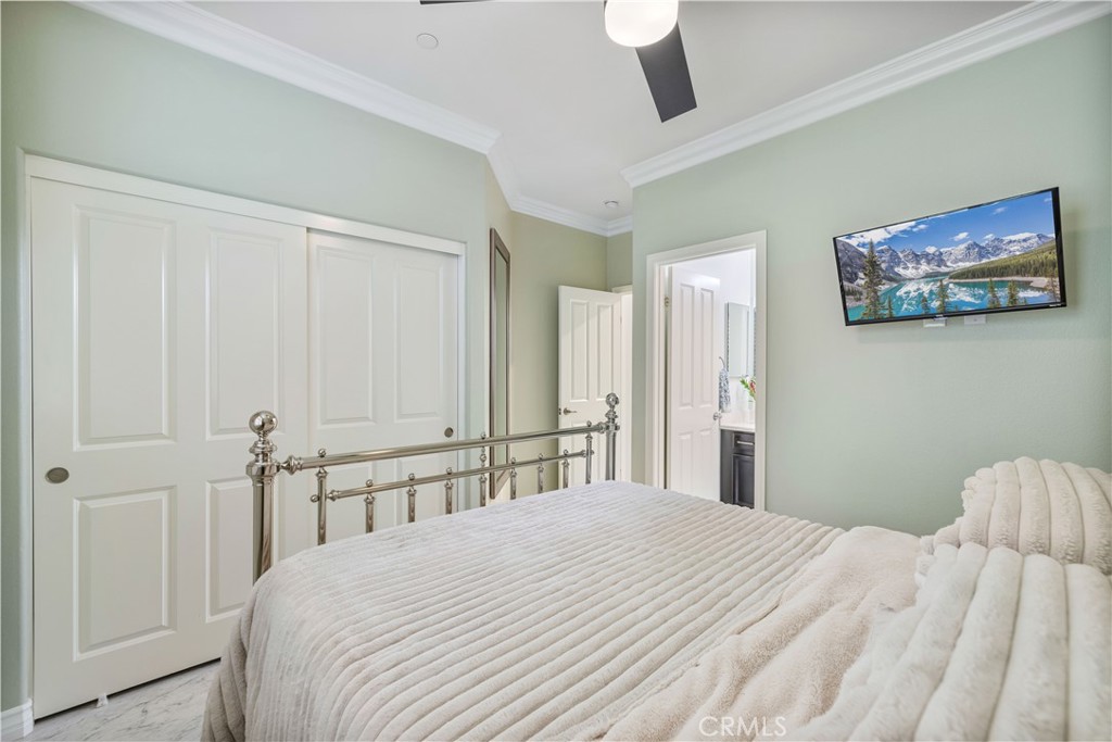 28537 Vista Del Rio Drive Valencia, CA 91354 - Photo 22 of 53 a bedroom with a large bed and a chandelier