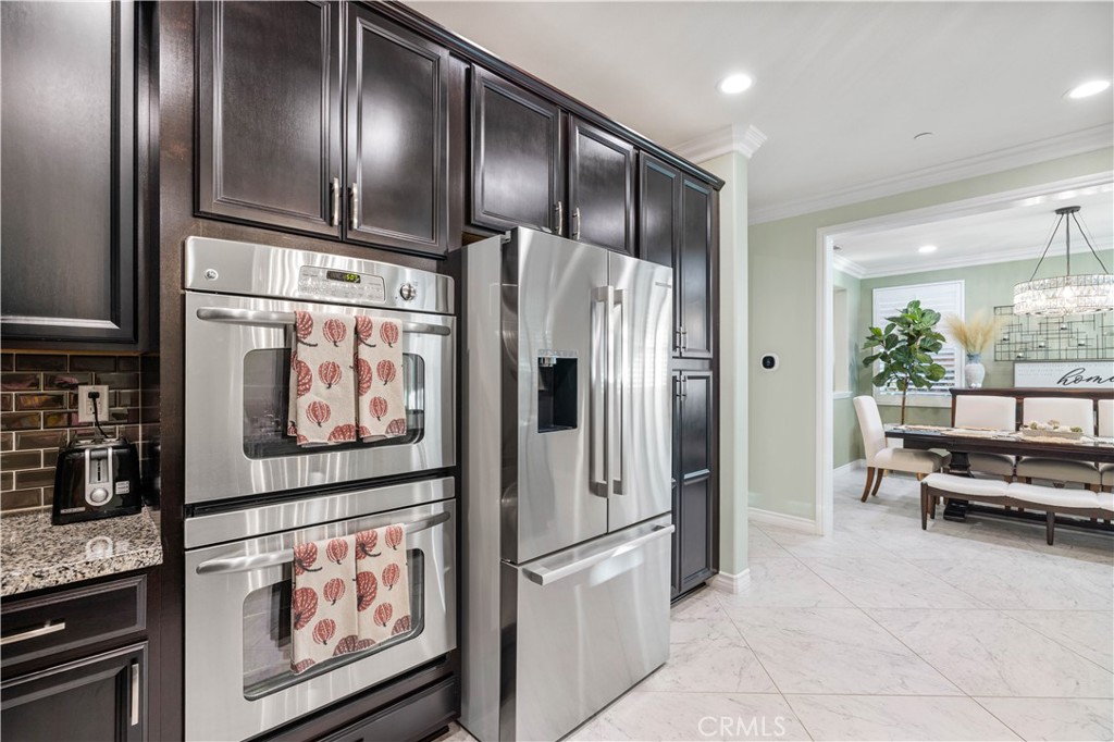 28537 Vista Del Rio Drive Valencia, CA 91354 - Photo 26 of 53 a kitchen with stainless steel appliances granite countertop a refrigerator and a stove