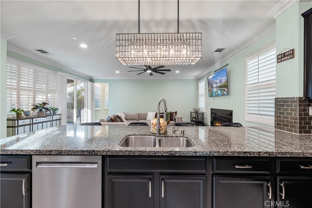 28537 Vista Del Rio Drive Valencia, CA 91354 - Photo 27 of 53 a kitchen with granite countertop a sink and a wooden floor