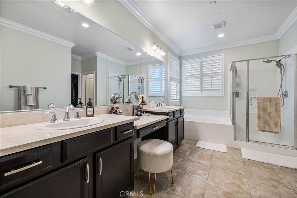 28537 Vista Del Rio Drive Valencia, CA 91354 - Photo 40 of 53 a bathroom with a granite countertop sink a toilet a mirror and shower