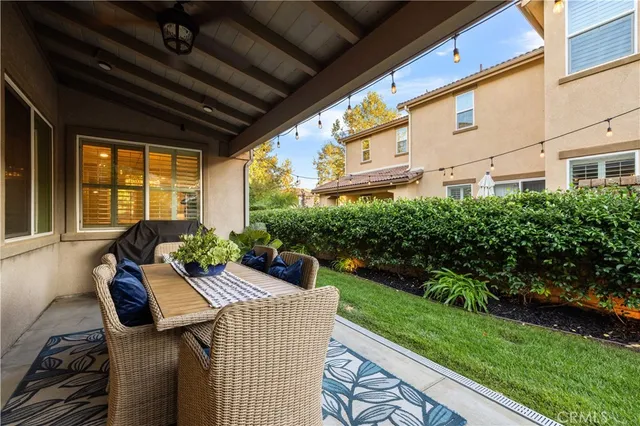 a view of a patio with a dining table and chairs