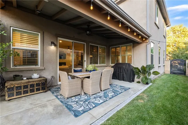 a view of a patio with table and chairs and potted plants
