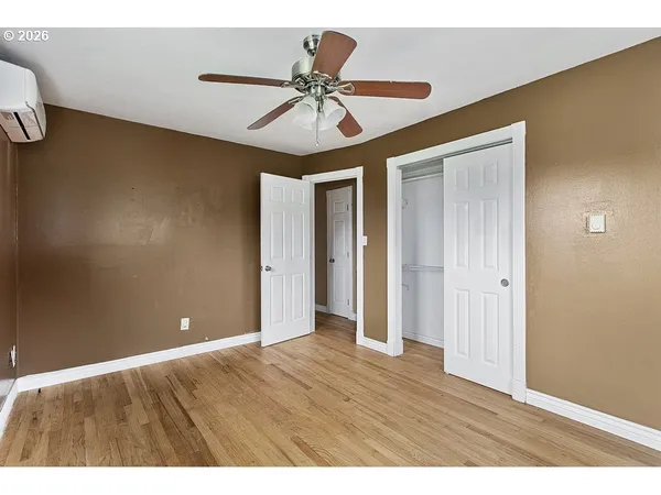 a view of an empty room with a ceiling fan