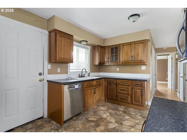 a kitchen with stainless steel appliances granite countertop a sink stove and cabinets