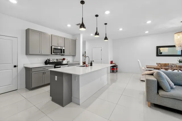 a spacious bedroom with a bed and a large window with balcony view