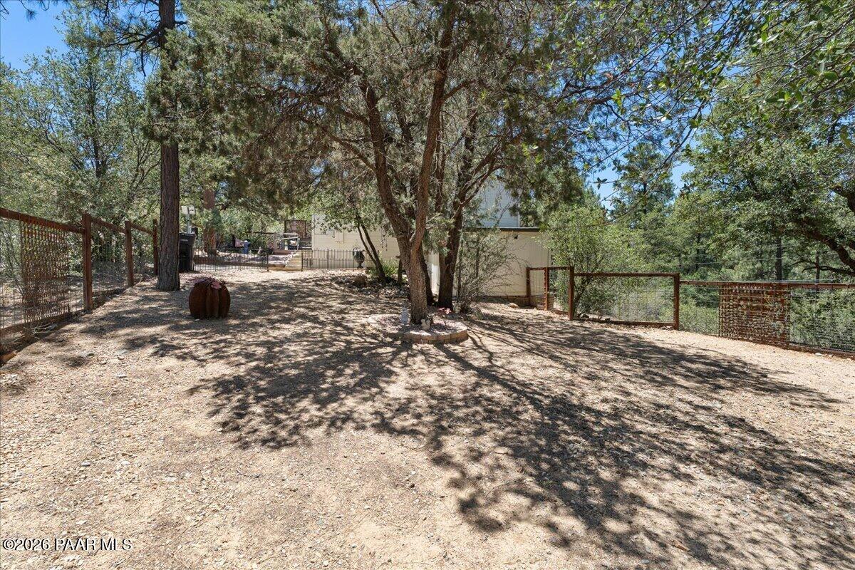1388 East Pine Ridge Drive Prescott, AZ 86303 - Photo 13 of 16 a view of a backyard with large trees