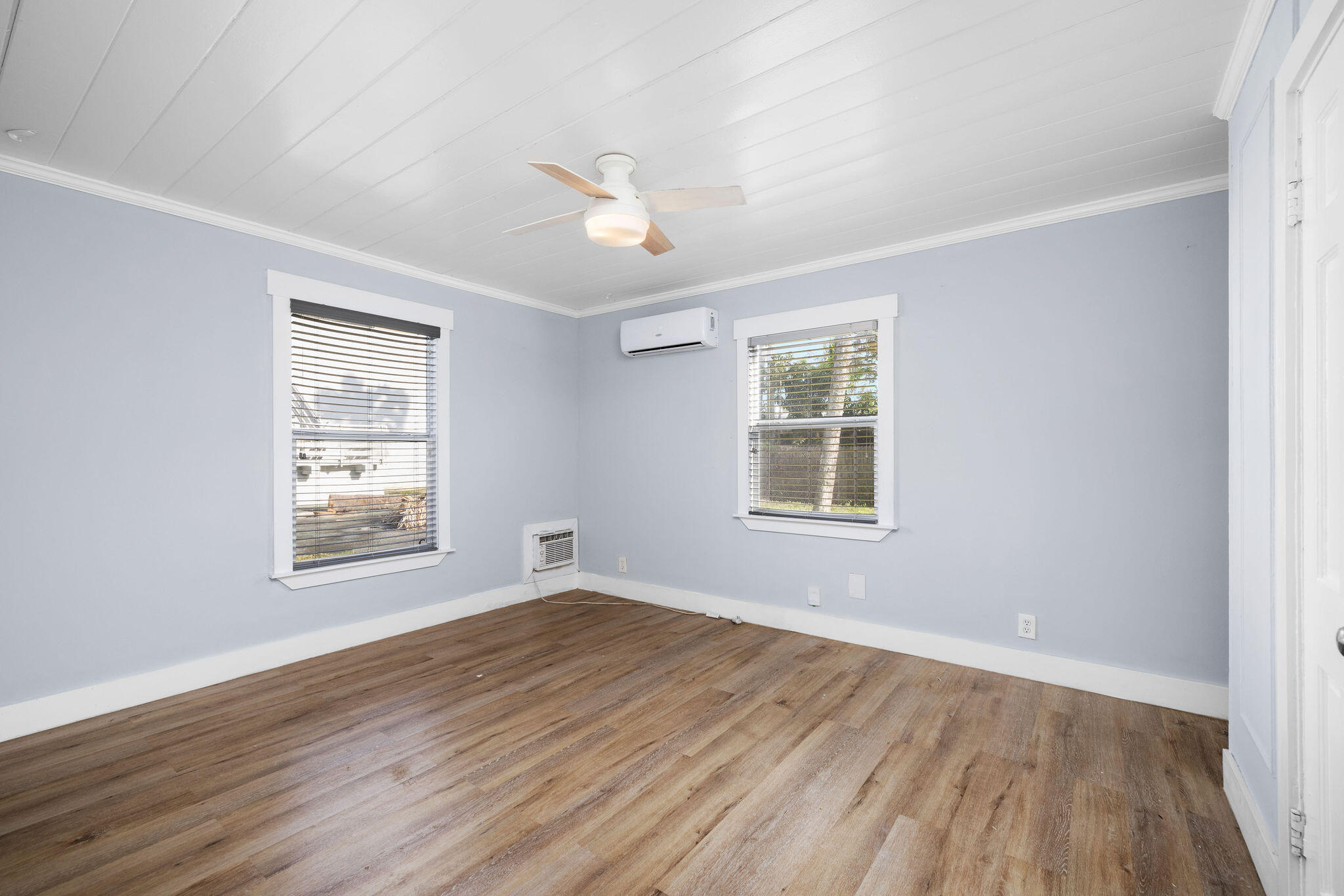 840 Almeria Road, Unit 2 West Palm Beach, FL 33405 - Photo 2 of 15 a view of an empty room with wooden floor and a window