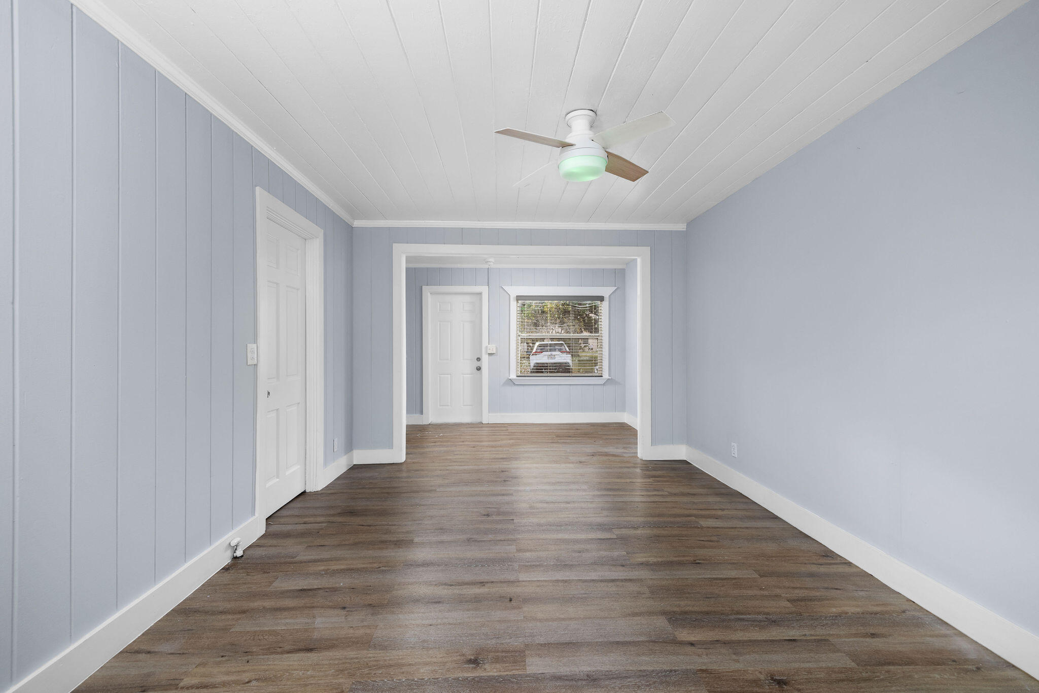 840 Almeria Road, Unit 2 West Palm Beach, FL 33405 - Photo 5 of 15 a view of an empty room with wooden floor and a window