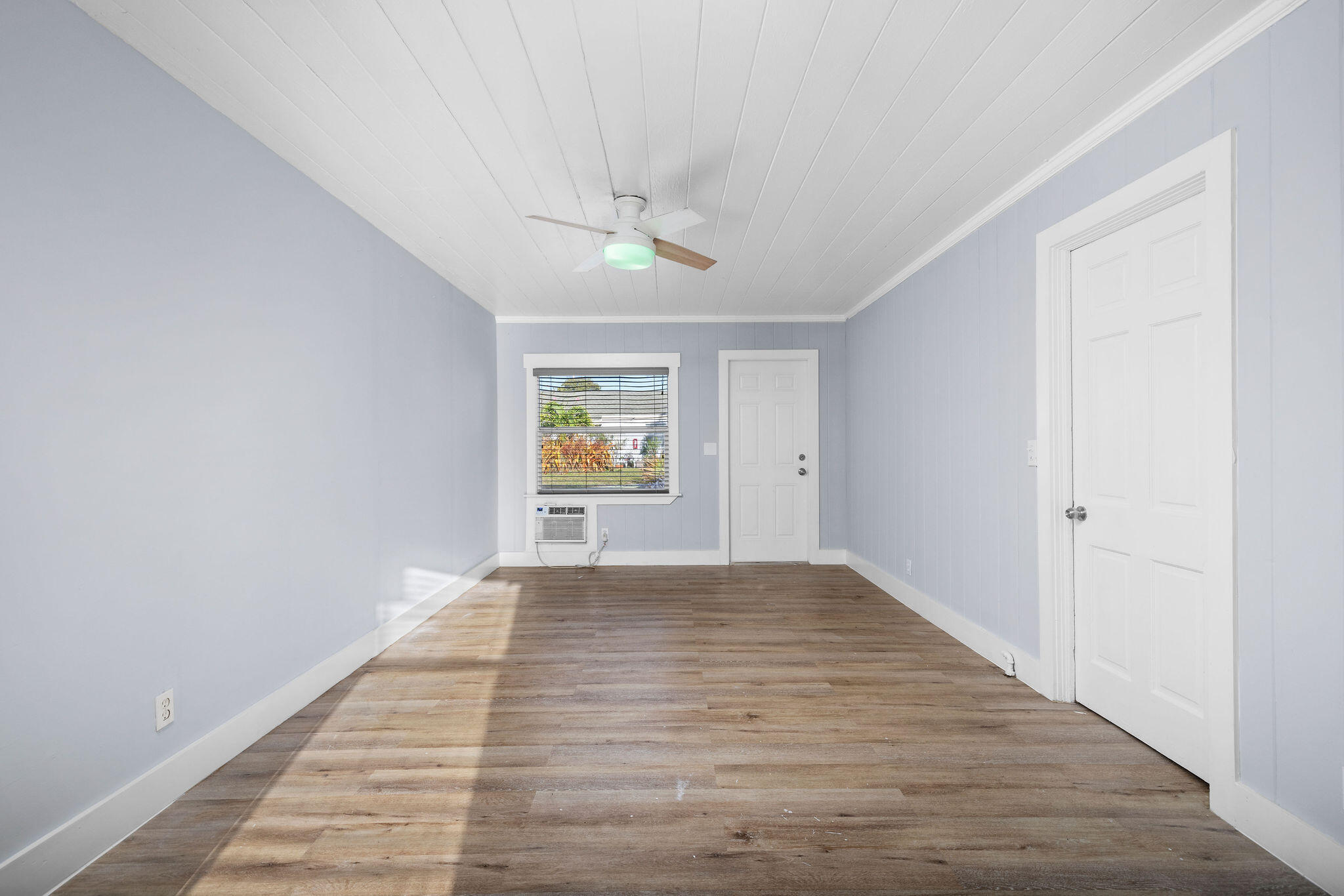 840 Almeria Road, Unit 2 West Palm Beach, FL 33405 - Photo 8 of 15 wooden floor in an empty room with a window