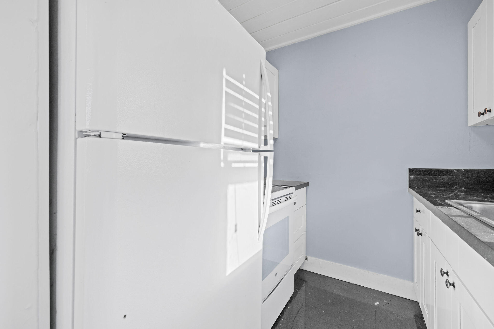 840 Almeria Road, Unit 2 West Palm Beach, FL 33405 - Photo 9 of 15 a room with white cabinets and white appliances