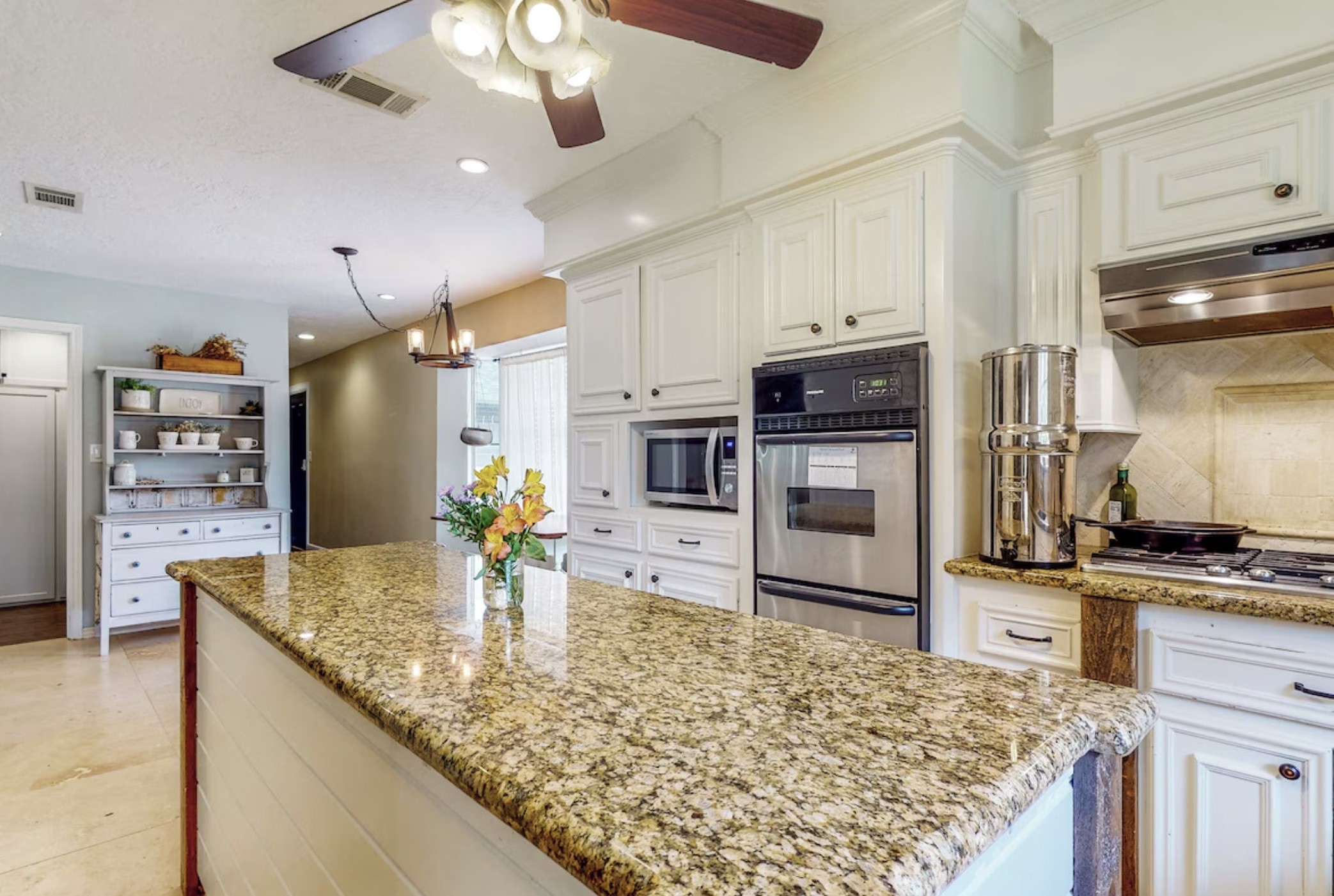 30819 Quinn Road Tomball, TX 77375 - Photo 6 of 30 a kitchen with stainless steel appliances wooden floor dining table and chairs