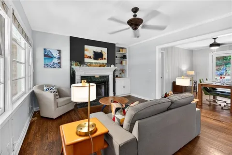 a living room with fireplace furniture and a flat screen tv