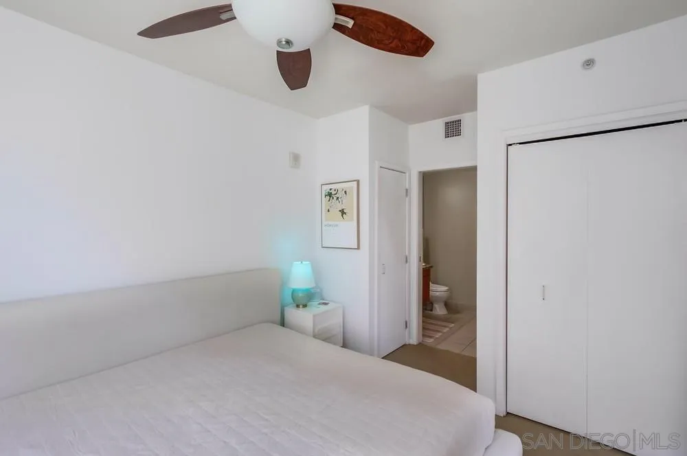 321 Tenth Avenue, Unit 903 San Diego, CA 92101 - Photo 13 of 55 a bedroom with a bed and a refrigerator