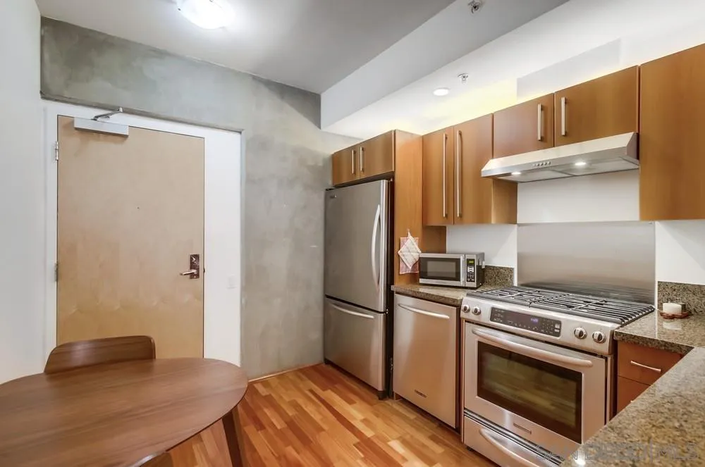 321 Tenth Avenue, Unit 903 San Diego, CA 92101 - Photo 4 of 55 a kitchen with a stove and a refrigerator