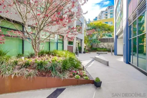 a front view of a house with a yard and a fountain