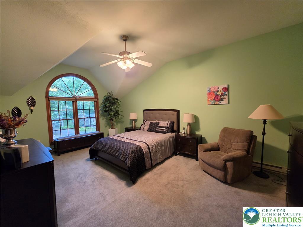 211 Murphy Circle Bushkill, PA 18324 - Photo 9 of 28 A graceful arched window illuminates this comfortable bedroom retreat.