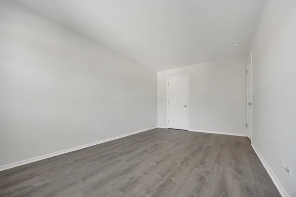 an empty room with wooden floor