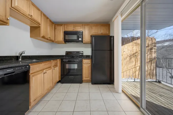 a kitchen with a refrigerator a stove top oven and a sink