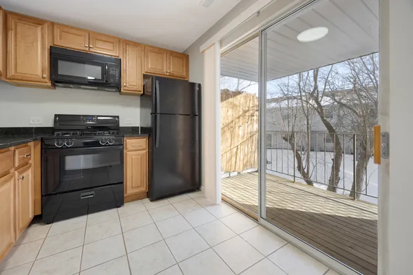a kitchen with a refrigerator a stove top oven and a refrigerator