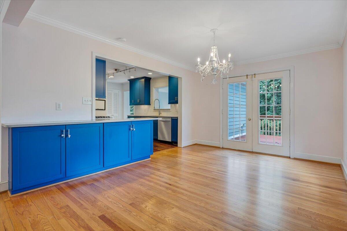 3135 West Ridge Road Southwest Roanoke, VA 24014 - Photo 11 of 50 a view of a kitchen with wooden floor and chandelier