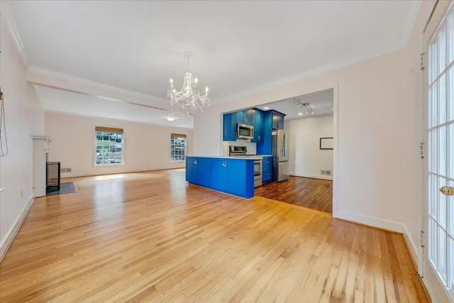a view of a kitchen with furniture and wooden floor