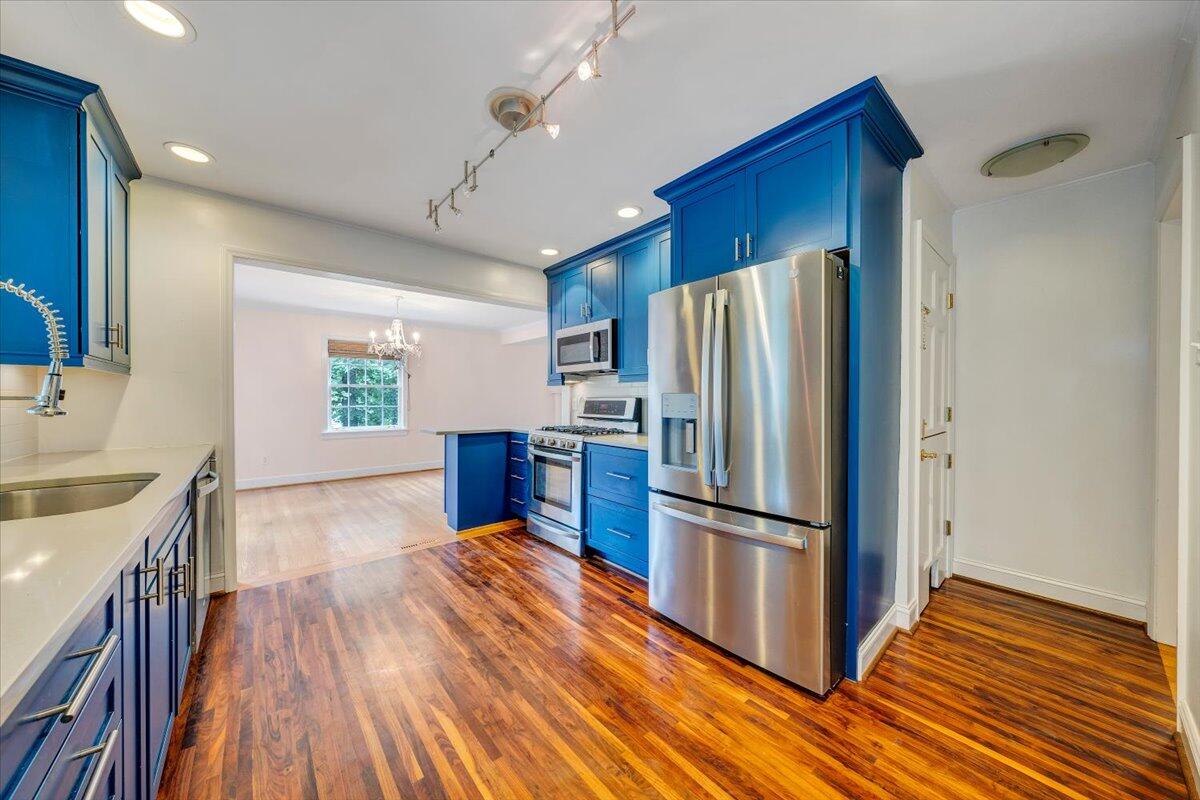 3135 West Ridge Road Southwest Roanoke, VA 24014 - Photo 17 of 50 a kitchen with wooden floors appliances and cabinets