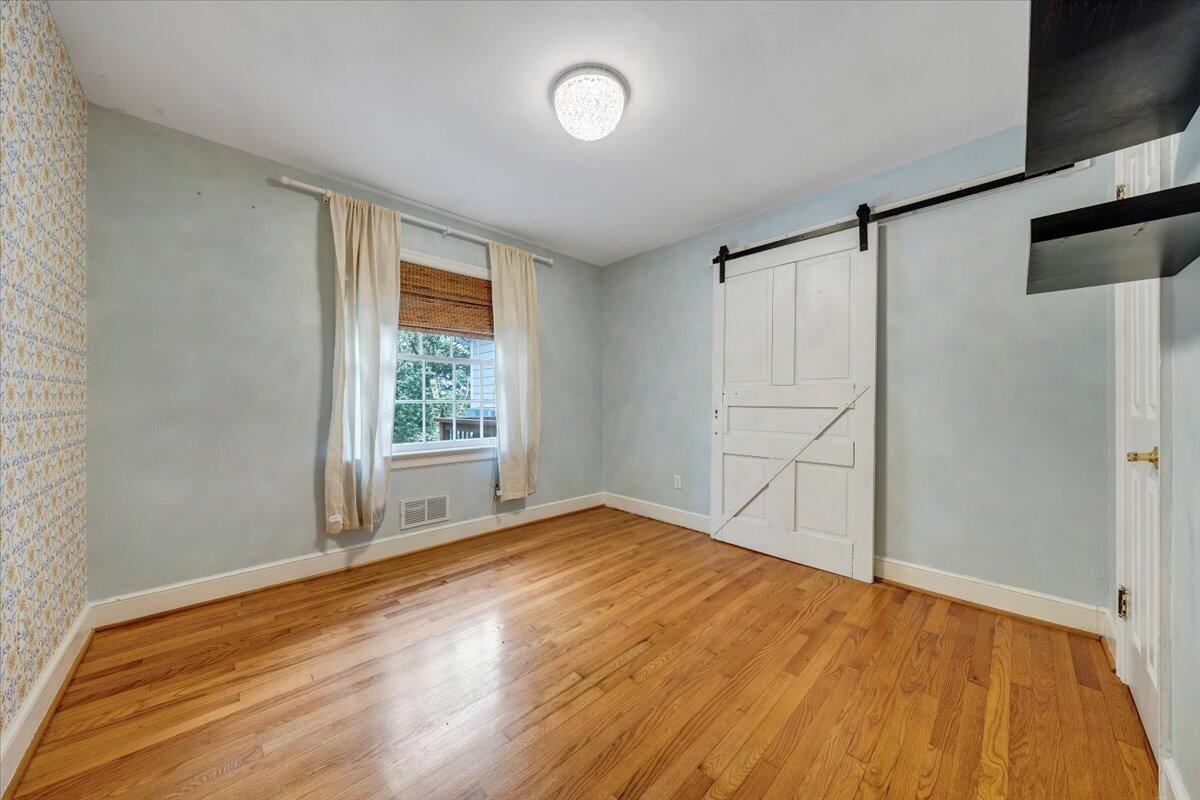 3135 West Ridge Road Southwest Roanoke, VA 24014 - Photo 26 of 50 a view of an empty room with wooden floor and a window