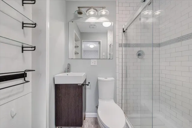 a bathroom with a toilet a sink and shower