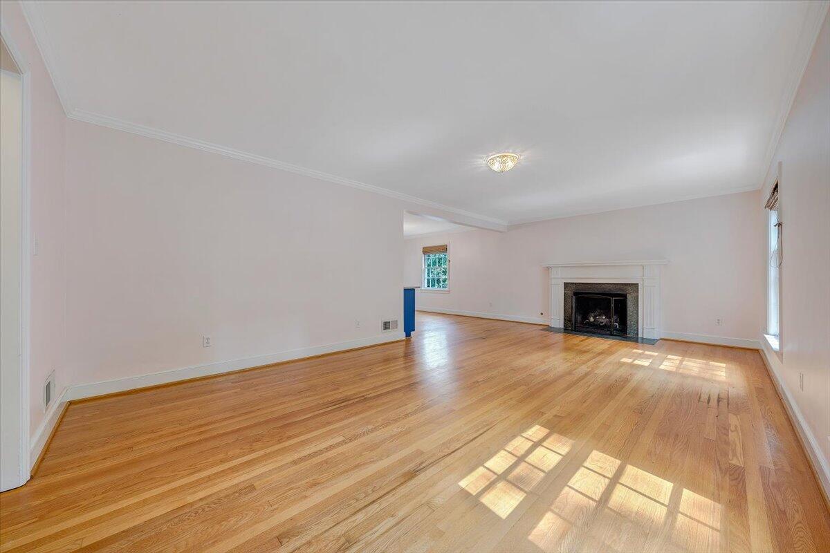 3135 West Ridge Road Southwest Roanoke, VA 24014 - Photo 5 of 50 a view of empty room with wooden floor and fireplace