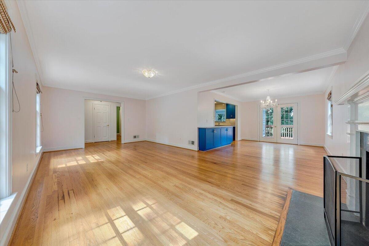 3135 West Ridge Road Southwest Roanoke, VA 24014 - Photo 7 of 50 a view of empty room with wooden floor and kitchen