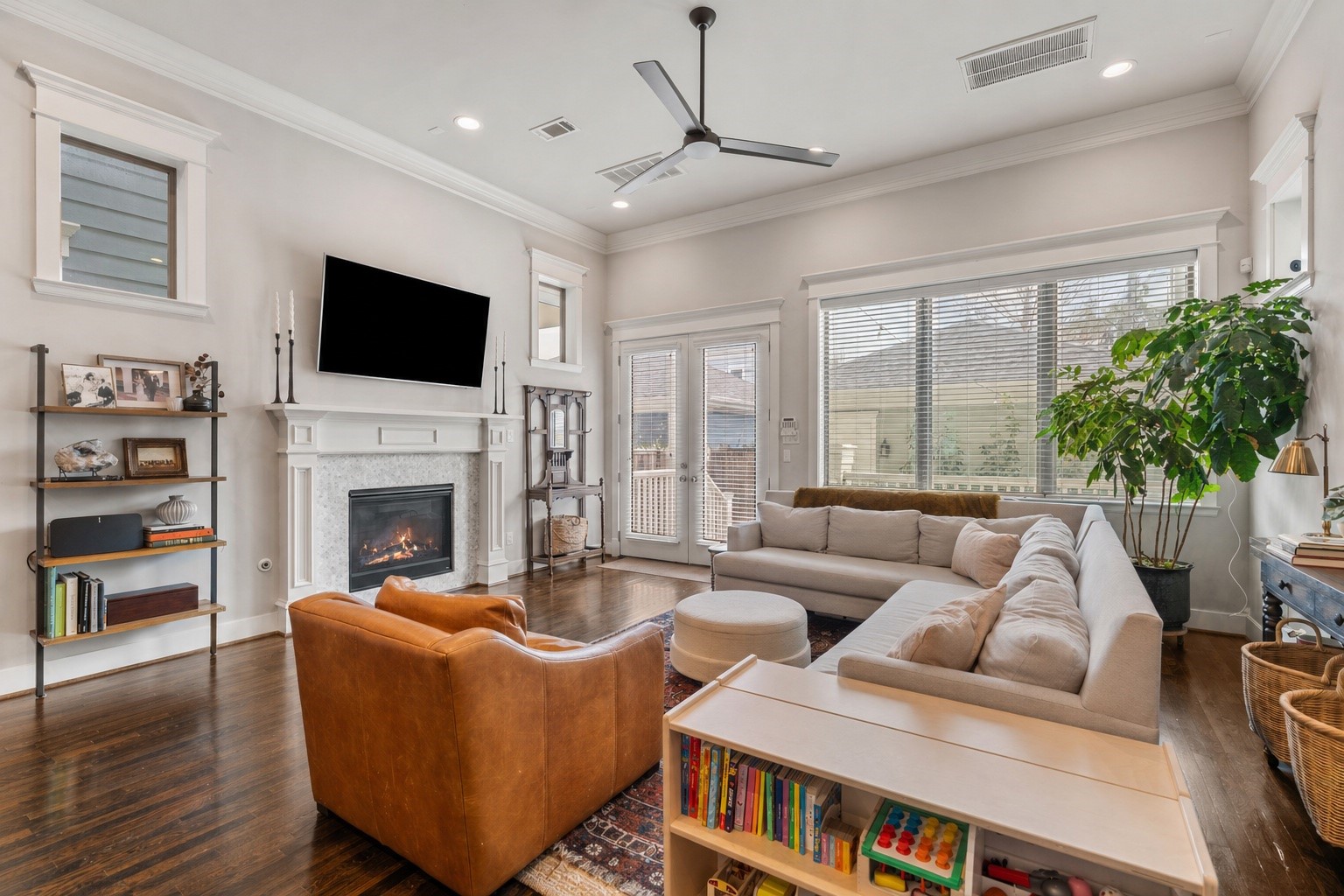 924 Aurora Street Houston, TX 77009 - Photo 15 of 37 Anchored by a fireplace, this space is perfect for everything from relaxed evenings by the fire to hosting friends and family.