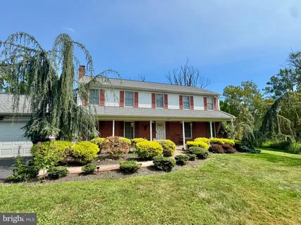 a front view of a house with swimming pool garden and patio