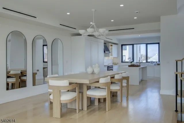 a view of a a dining room with furniture window and wooden floor