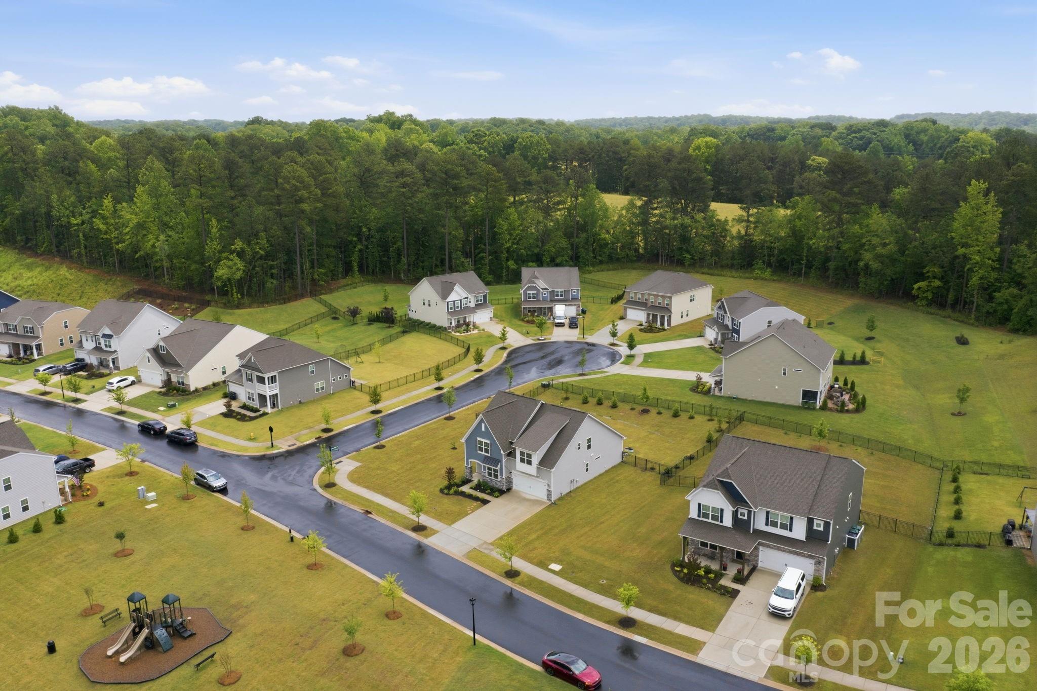 234 Hamptons Cove Road Troutman, NC 28166 - Photo 27 of 32 an aerial view of a house with swimming pool big yard and large trees