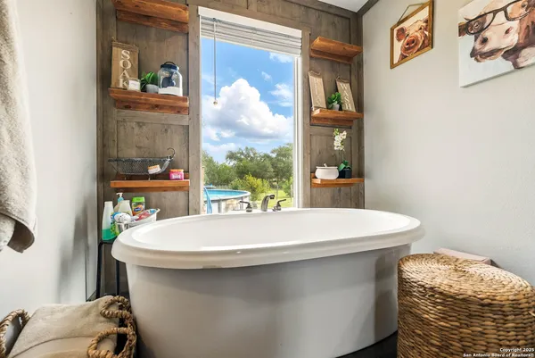 a bedroom with furniture and a window