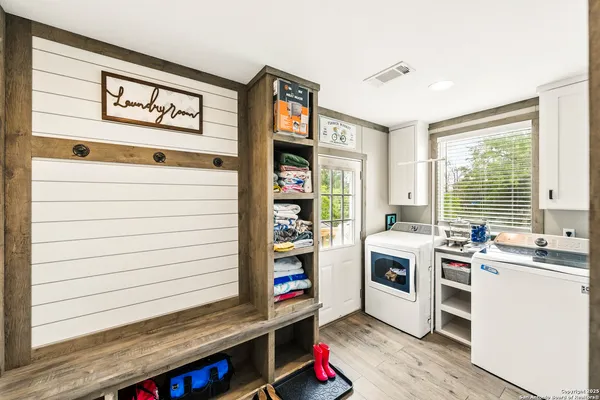 a view of a swimming pool and lounge chairs in back of the house