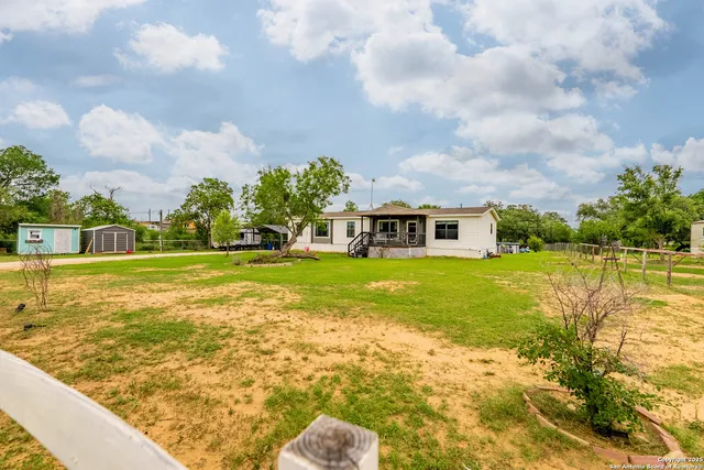 a front view of house with yard and green space