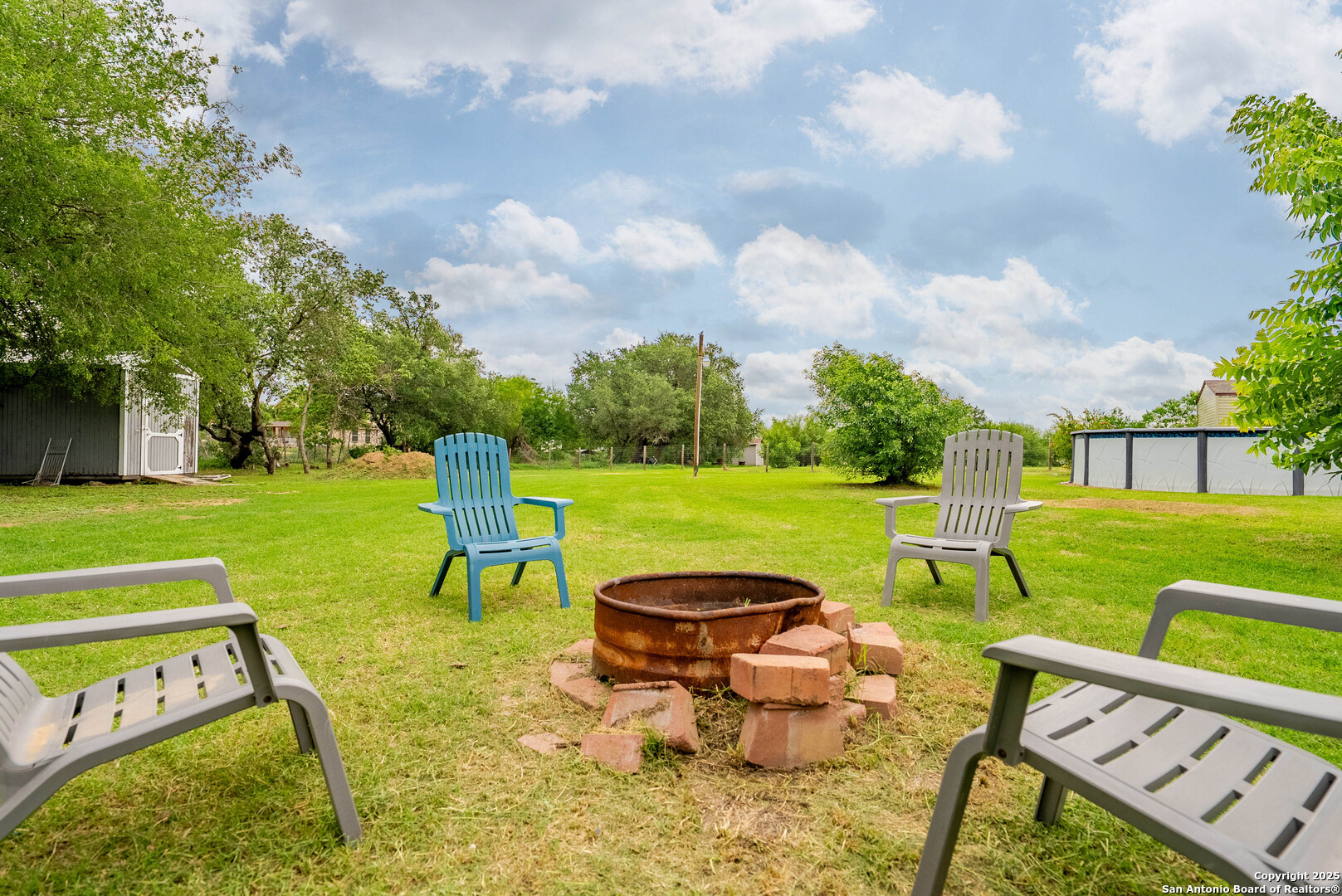 238 Las Palomas Drive Lytle, TX 78052 - Photo 18 of 25 a view of a swimming pool and lounge chairs in back of the house